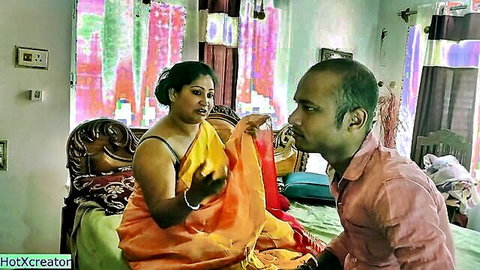 Indian woman in saree gesturing to man in bedroom foreplay scene