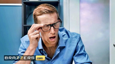 Shocked blonde guy in glasses and blue shirt reacts intensely in office Brazzers scene