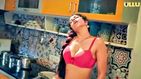 Sexy Indian woman in pink bra teasing with deep cleavage