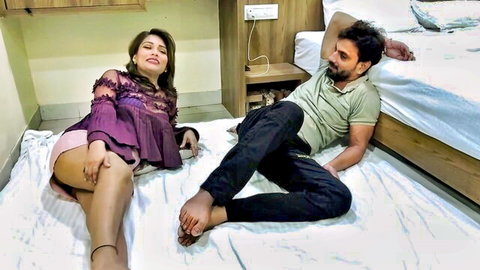 Indian hotwife nurse in sexy purple top and shorts lounges with man on bed