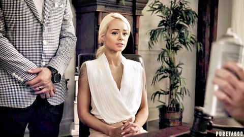 Elsa Jean in white draped dress sits tensely as man holds spray can in PureTaboo scene