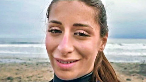 Silvia Soprano smiling in black wetsuit on Norwegian beach