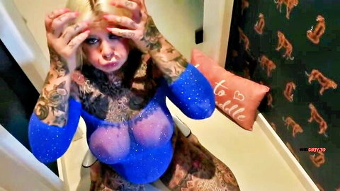 Tattooed blonde SteffiBlond in sheer blue lingerie, ecstatic expression