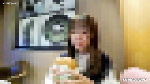 Cute Asian girl in black top smiling at table with snacks