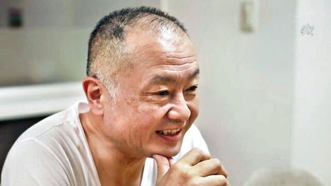 Mature Asian man smiling warmly in white t-shirt, caring stepdad vibe