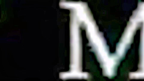Pixelated white M letters on black background