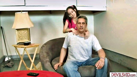 Petite Asian stepdaughter massages shoulders of white stepdad