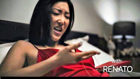 Emiri Momota in red slip dress, intense expression on bed