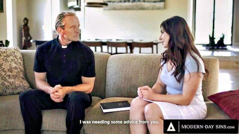 Keira Croft in light blouse and skirt seeks advice from priest on couch