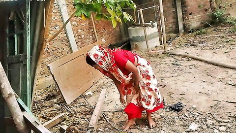 Desi Indian bhabhi bending over in village sari, teasing ass