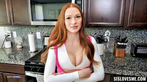 Harley Love redhead in low-cut top, teasing cleavage closeup