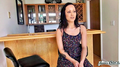 Young skinny brunette with small tits in floral dress sitting smiling at home bar audition