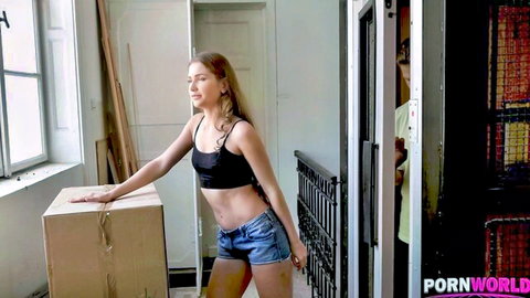 Mary Rock in black crop top and denim shorts, teasing side pose