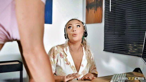 Curvy blonde in open satin robe, headphones on, surprised expression in office tease