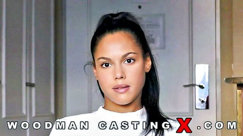 Young tanned brunette petite girl in Woodman casting interview wearing tight white top