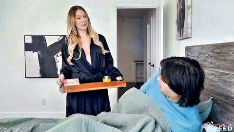 Blonde MILF stepmom in open black robe showing big tits brings tray to surprised stepson in bed