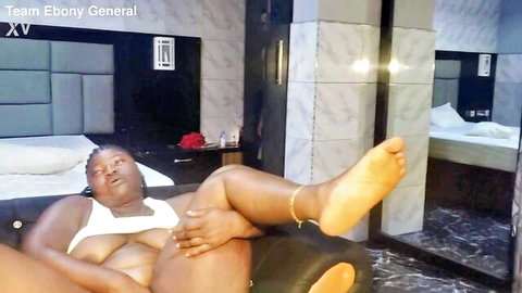 Ebony BBW spreads legs wide on bed exposing massive black tits in tight white top