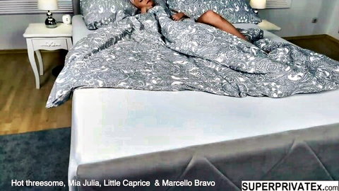 Mia Julia and Little Caprice teasing in bed with Marcello Bravo