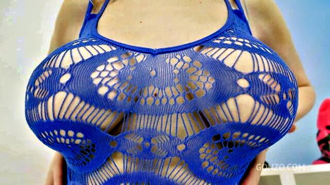 Rebel in blue mesh lingerie showcasing massive breasts