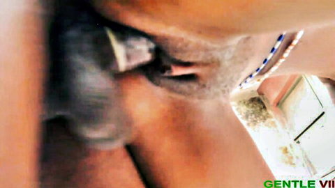 Intense close-up of bearded ebony man's face with blue beads during rough sex