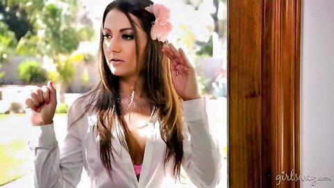 Brunette teen teases deep cleavage in unbuttoned white blouse and pink bra outdoors with flower in hair