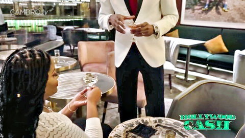 Ebony beauty Jayla in white sweater flirts with suited man holding drinks