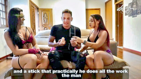 Two Brazilian women in lingerie with man holding dildo backstage