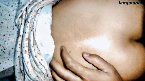 Hand groping curvy South Asian babe's bare belly and hip closeup