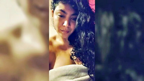 Sexy brunette webcam girl in towel showing cleavage, amateur cam tease