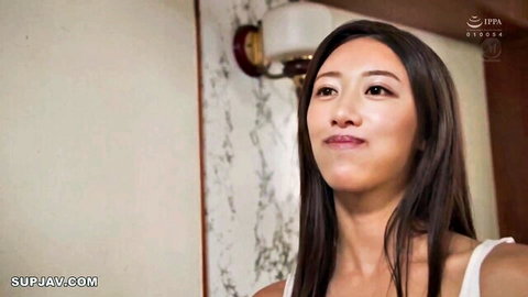 Seductive Asian woman with long dark hair in white tank top
