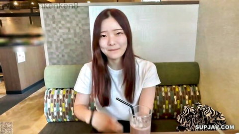 Young Asian teen with fresh smile holding drink, casual white top