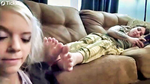 Blonde and tattooed girls lounging casually, bare soles and feet prominently displayed