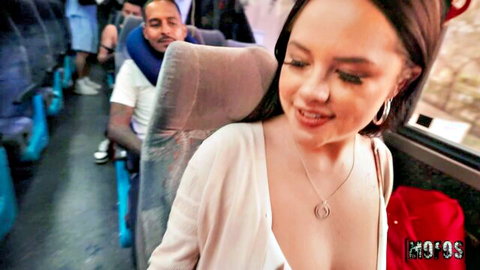 Busty teen flashes deep cleavage smiling seductively on crowded public bus