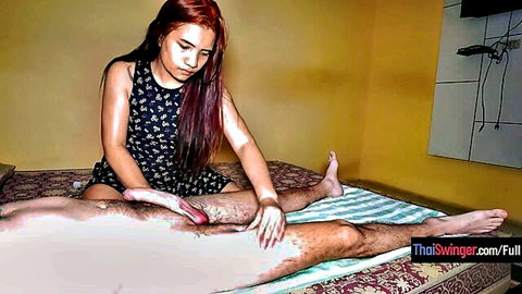 Redhead Thai babe massages big erect cock during happy ending handjob massage