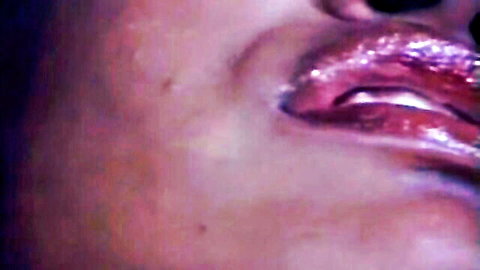 Seductive close-up of glossy purple lips from vintage porn The Girl From Rio