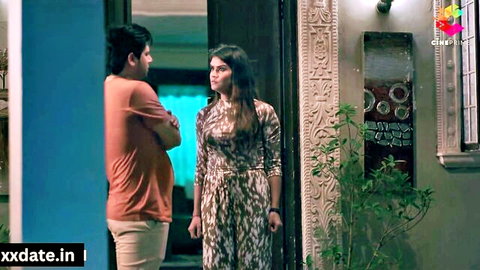 Indian brunette in sexy dress faces young man in t-shirt at ornate home doorway, teasing taboo encounter