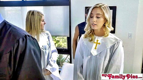 Blonde teen in white nun outfit with cross necklace standing with suited stepdad in taboo scene