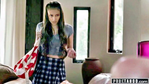Slim brunette teen in plaid skirt and crop top with stepdad in background