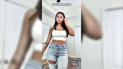 Sophie Rain teasing in white crop top and ripped jeans, showing curves