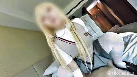 Blonde cosplayer in sexy school uniform posing solo on bed