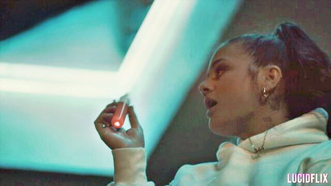 Ryan Reid in white hoodie holding red light, neon-lit pose