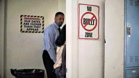 Ebony DILF in suit stands behind petite ebony babe in tight white top in school hallway