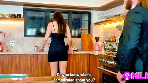 Sexy MILF in tight short black dress bends over kitchen counter teasing big ass for suited man