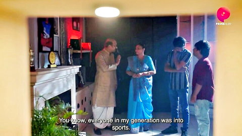 Indian family in traditional attire discussing generational sports