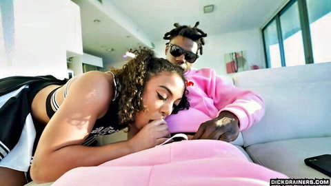Curly haired cheerleader in uniform deepthroats massive black cock on couch