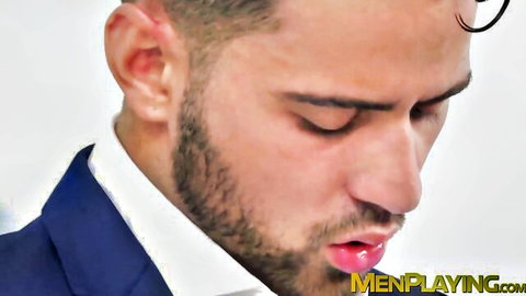 Bearded suited hunk eyes closed lips parted in gay blowjob ecstasy