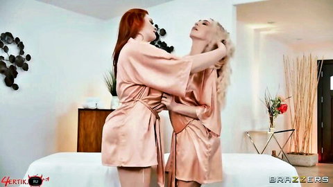Abigaiil Morris and Kendra Sunderland in intimate lesbian embrace in silk robes