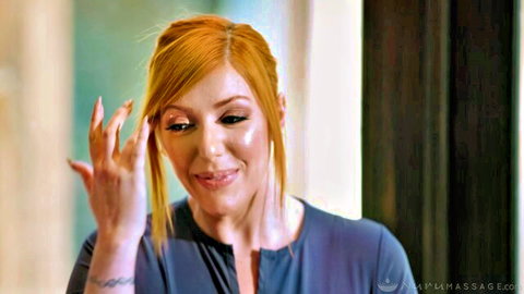 Redhead MILF in tight blue top seductively gestures with tattooed arm
