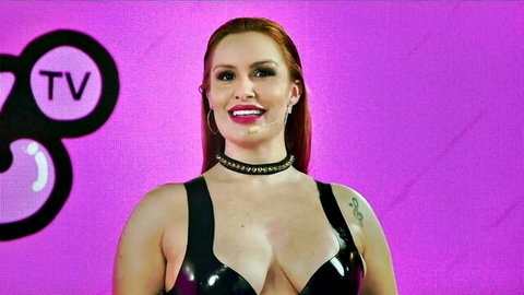 Redhead beauty in shiny black latex top and choker for fetish exploration