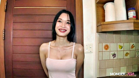 Gorgeous sexy Thai teen smiling in tight pink tank top